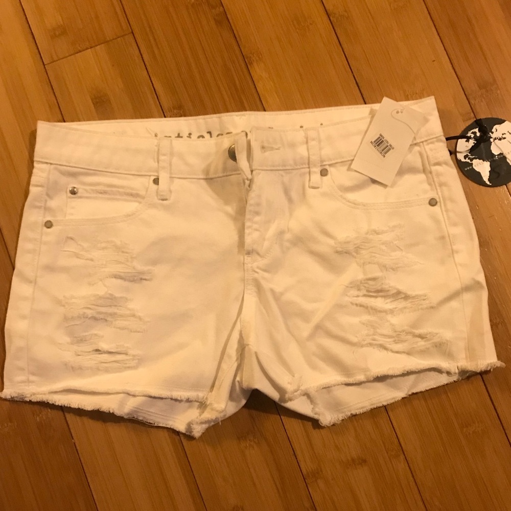 Distressed white jean shorts